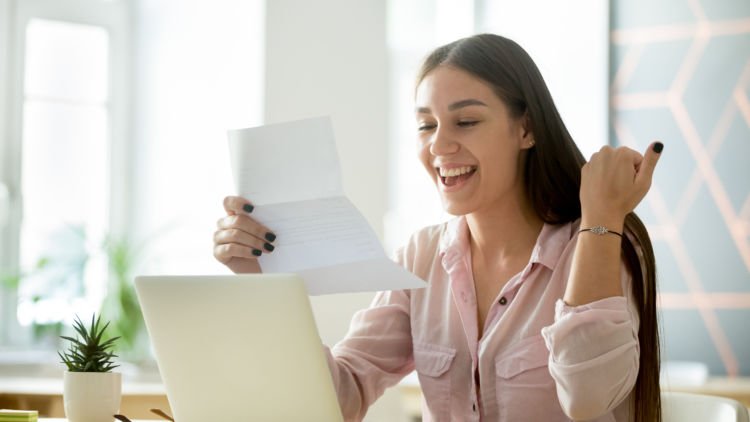 woman excited reading letter